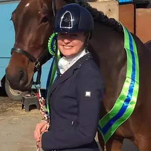 An insurance guru posing with her horse