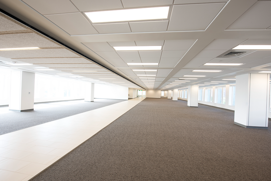 commercial office space with illuminated ceiling lights