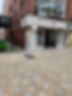 Small boutique on a cobblestone alley with mannequins in colorful dresses.