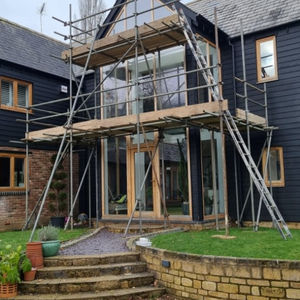 a house with garden and scaffolding