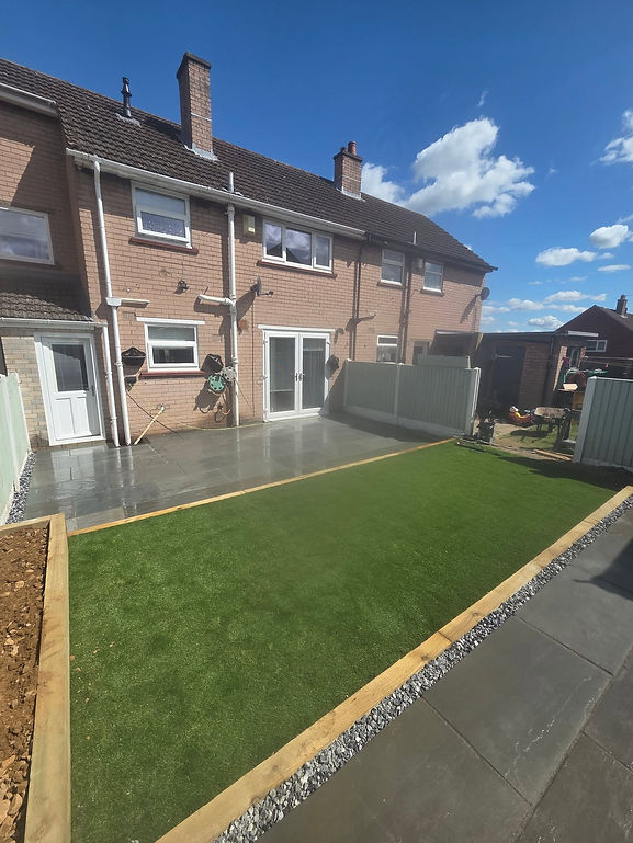 house exterior with patio area and green grass