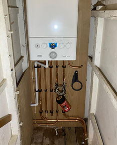 white boiler and pipe system on wall
