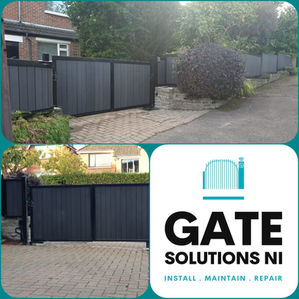 A newly installed black sliding gate at a residential property, with the installer's logo, "GATE SOLUTIONS NI," displayed below.
