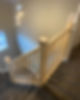 Carpeted staircase with a new light wood railing
