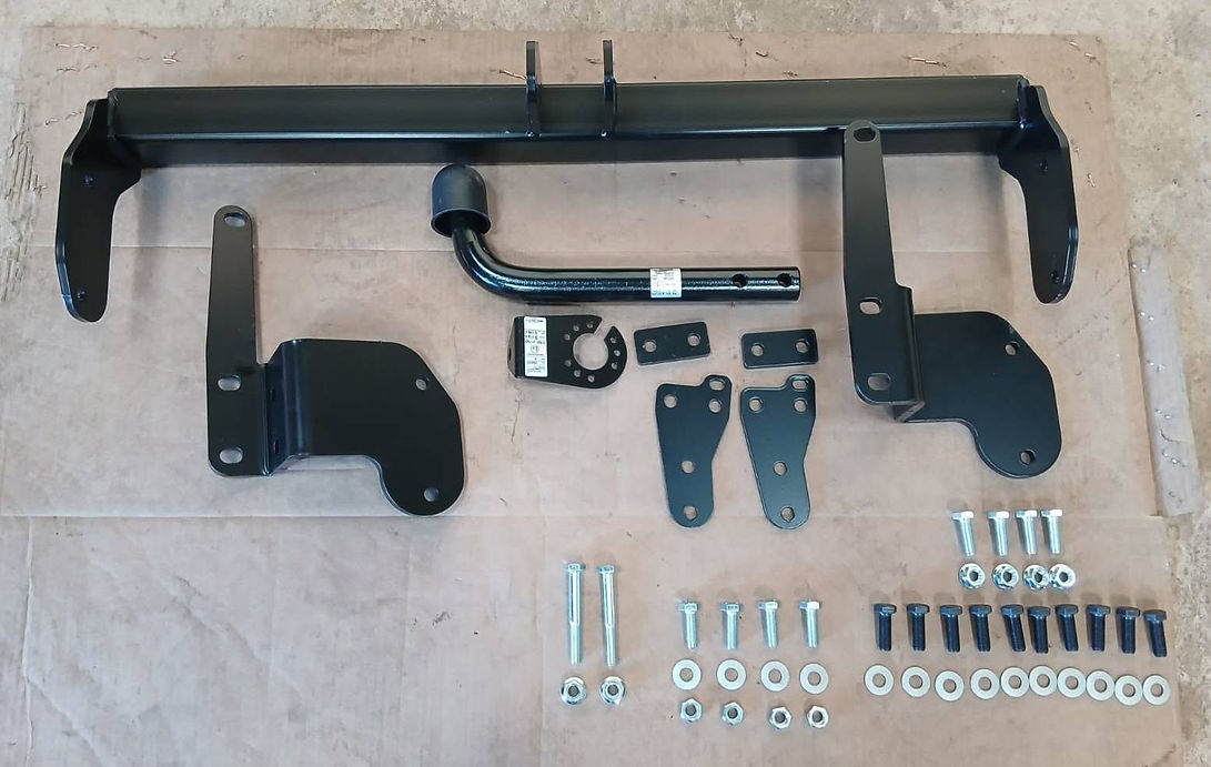 A collection of vehicle parts, prominently featuring a towbar among other components