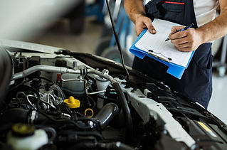 an auto mechanic's hand with clipboard and pen