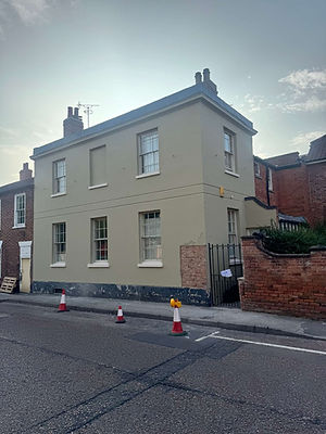 exterior of a building with red cones on road