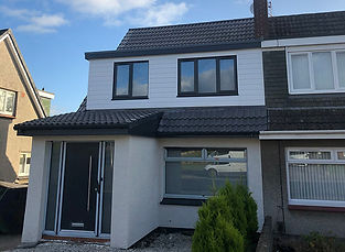 front view of a house with windows and a dark door