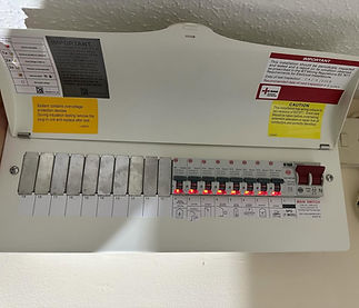 Open electrical panel with multiple circuit breakers