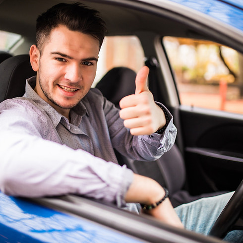 a happy man in a car