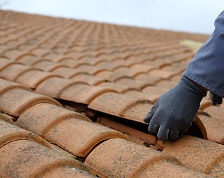 a worker replacing roof tile