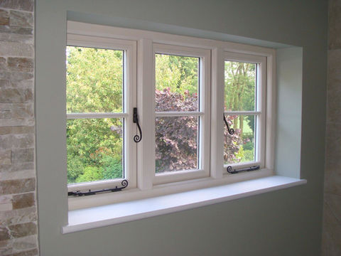 Windows with white frames and black handles