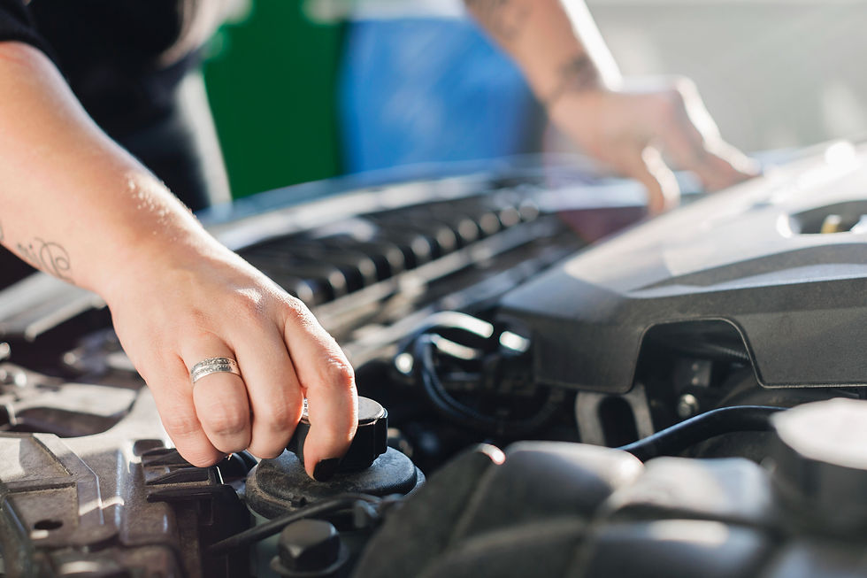 close-up image of a person's hand while inspecting car's engine