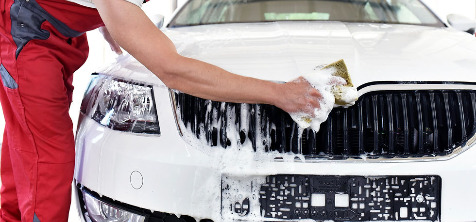 a man cleaning car exterior