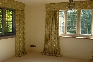 windows with curtains in a room