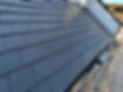 close-up image of black tiles on a roof