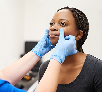 professional aesthetician examining patient's face