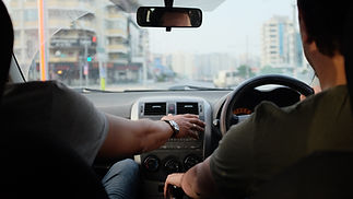 instructor guiding a person during a driving lesson