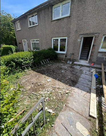 front view of a house with green bushes