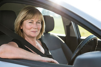 smiling woman in a car