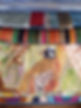 Close-up of stacked fabric swatches featuring various patterns including a colorful plaid, stripes, and a detailed bird