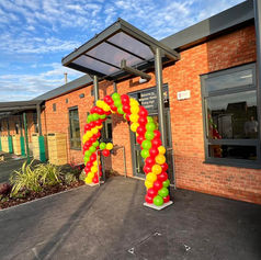 balloon arch outside a commercial building