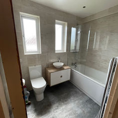 bathroom with windows and bathtub with glass wall