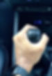 a person's hand while holding gear shift lever
