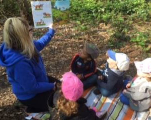 A woman reading a story to a group of children