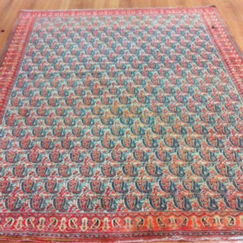 A colorful oriental rug lies on the floor