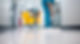 A person in a teal uniform mops a shiny, clean hallway floor