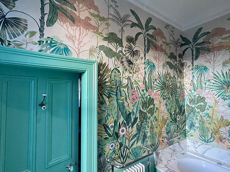 A bathroom decorated with vibrant wallpaper