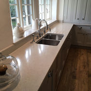 A kitchen featuring a sink and countertop, showcasing a clean and organized cooking space.