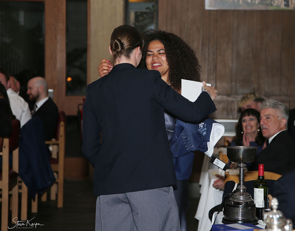 Estelle Onwuka #423 receiving her award from newly elected Women*s President: Poppy Burrows #425