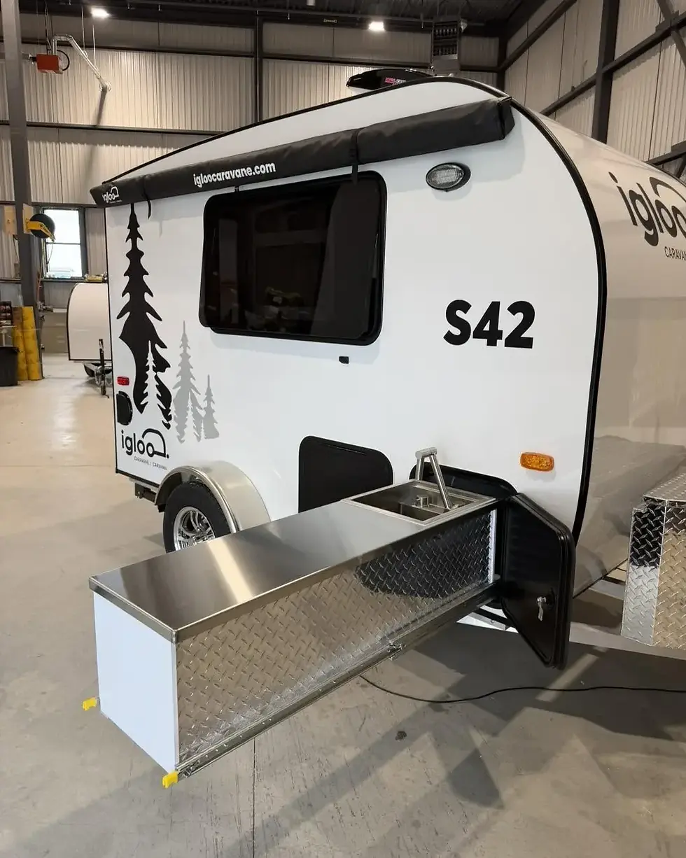 Slide-out outdoor kitchen with built-in sink, extended from the side of the S42 teardrop trailer