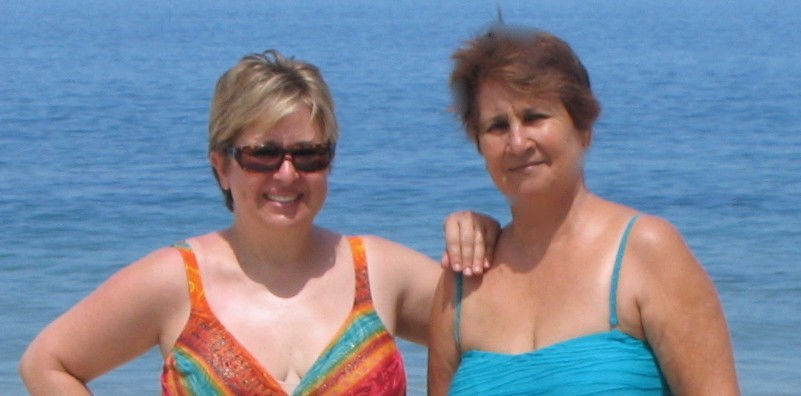 Two ladies posing in a swimsuit.