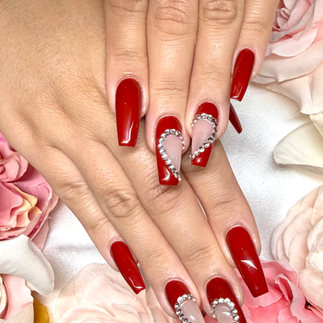 red nails painted with glitter on top