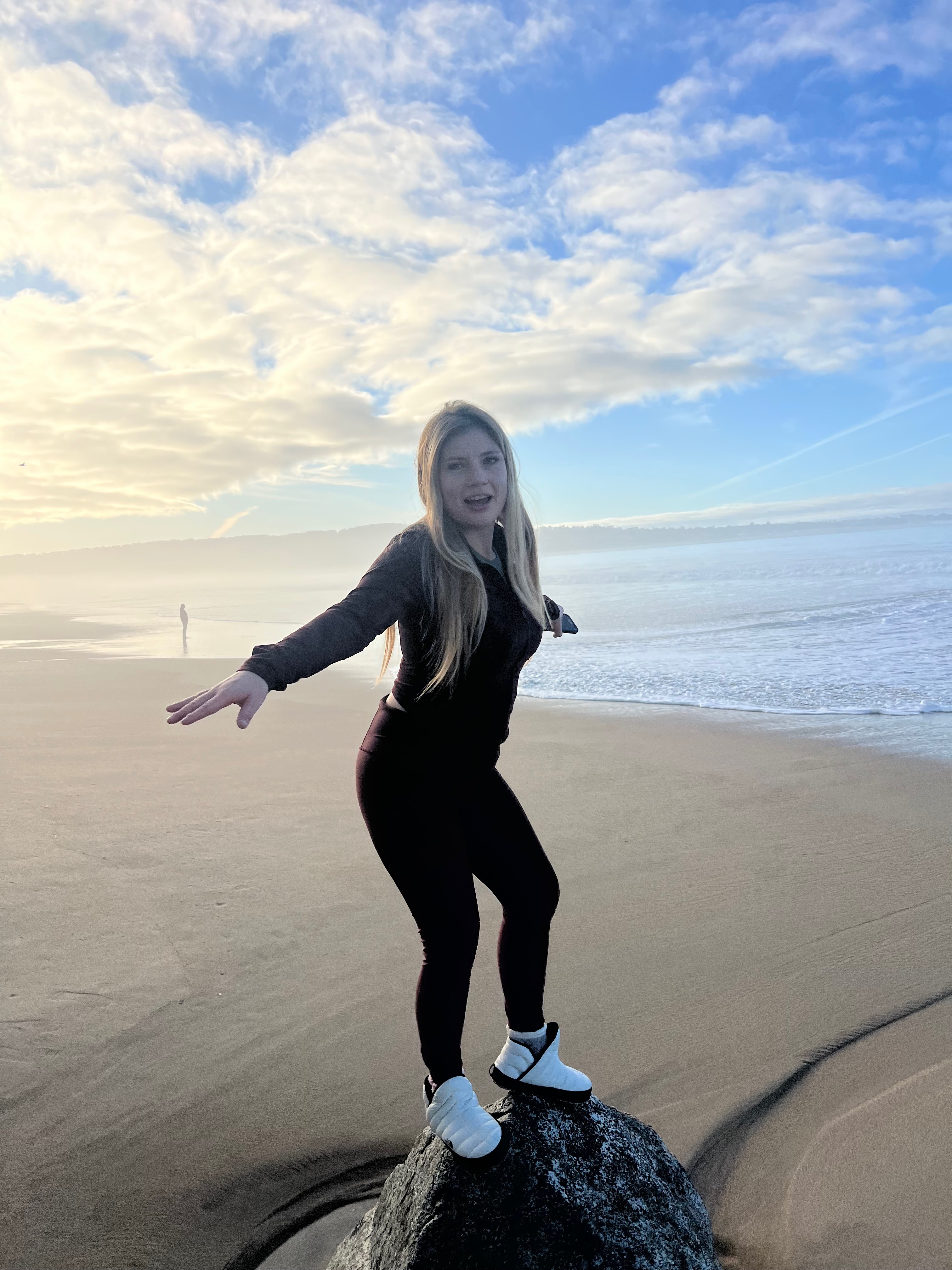 Hannah standing on a rock.