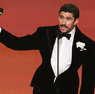 Bad Bunny holding an award in Grammy's.
