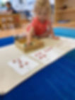 toddler using Montessori math materials