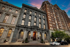 Three mid-rise buildings at sunset