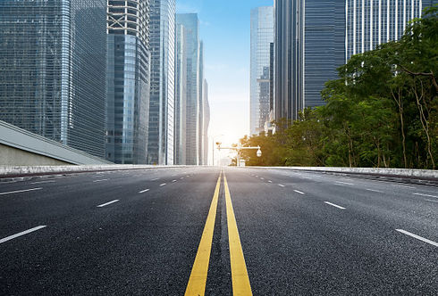 empty-highway-with-cityscape-skyline-she