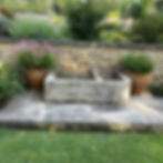 Pots flanking a water trough