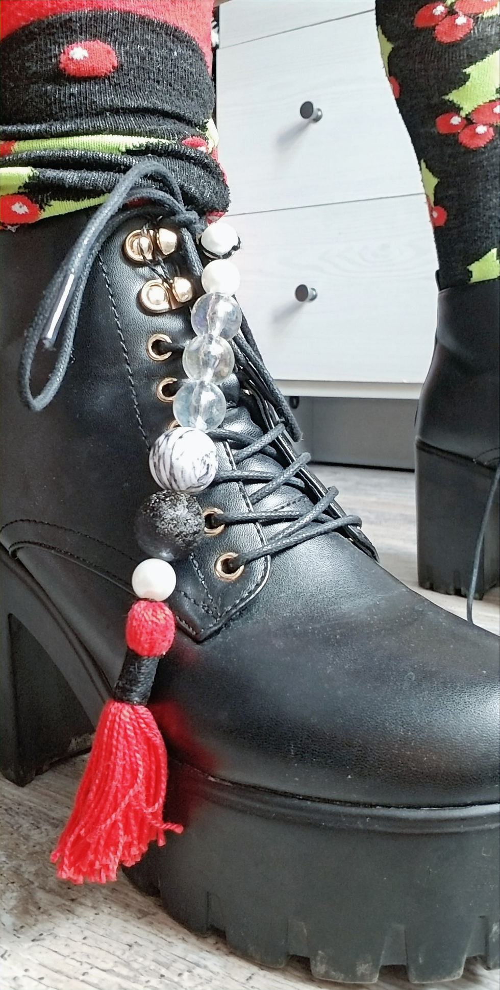 Black boots with decorative beaded tassels