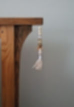 Wooden table with beaded tassel