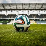 Colourful football on grass in a stadium