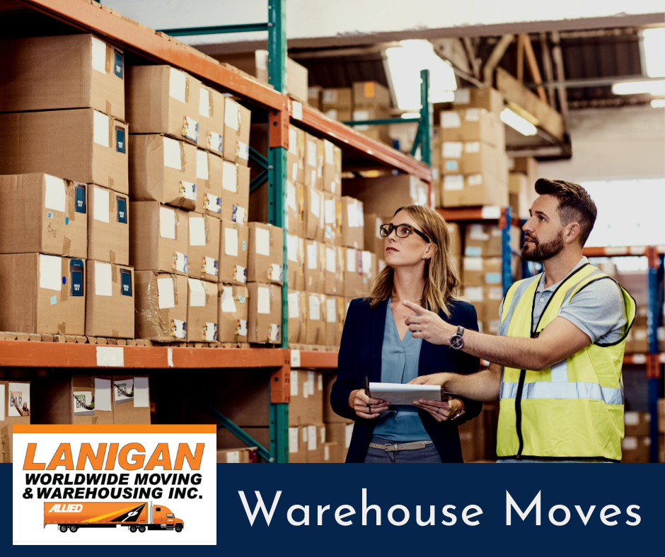 warehouse movers in jackson ms - a female manager holding a clip board speaking with a male mover wearing a yellow vest - shelves are loaded with boxes