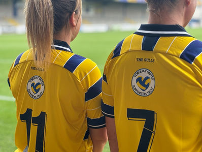 TUST logo above the shirt numbers on the back of the Women's shirts