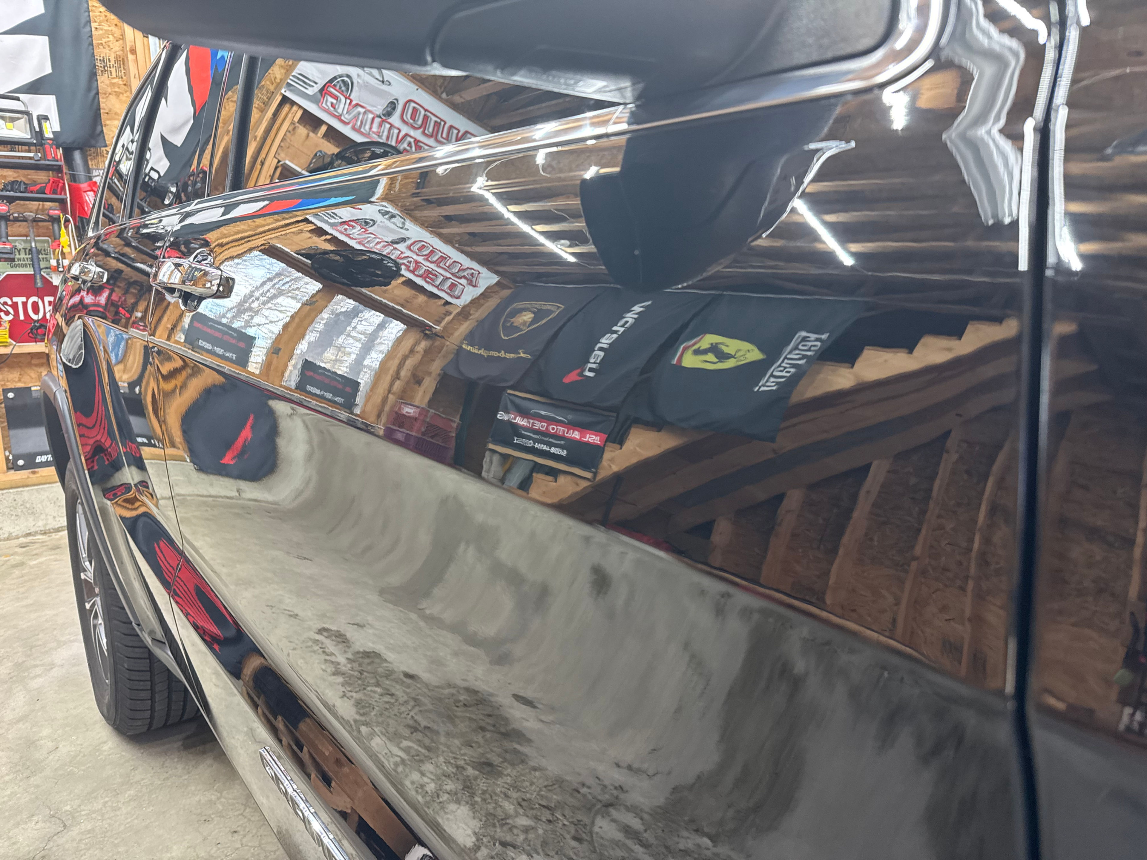 The shop reflected in freshly finished black paint