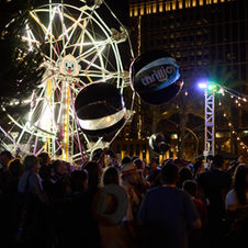 Comic-Con experiential activation featuring Ferris wheel, carnival games, and large-scale event production with high-energy crowd.